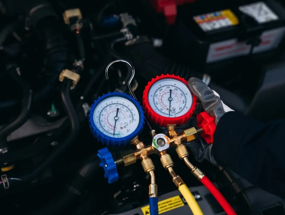 Car air conditioning system being tested and regassed