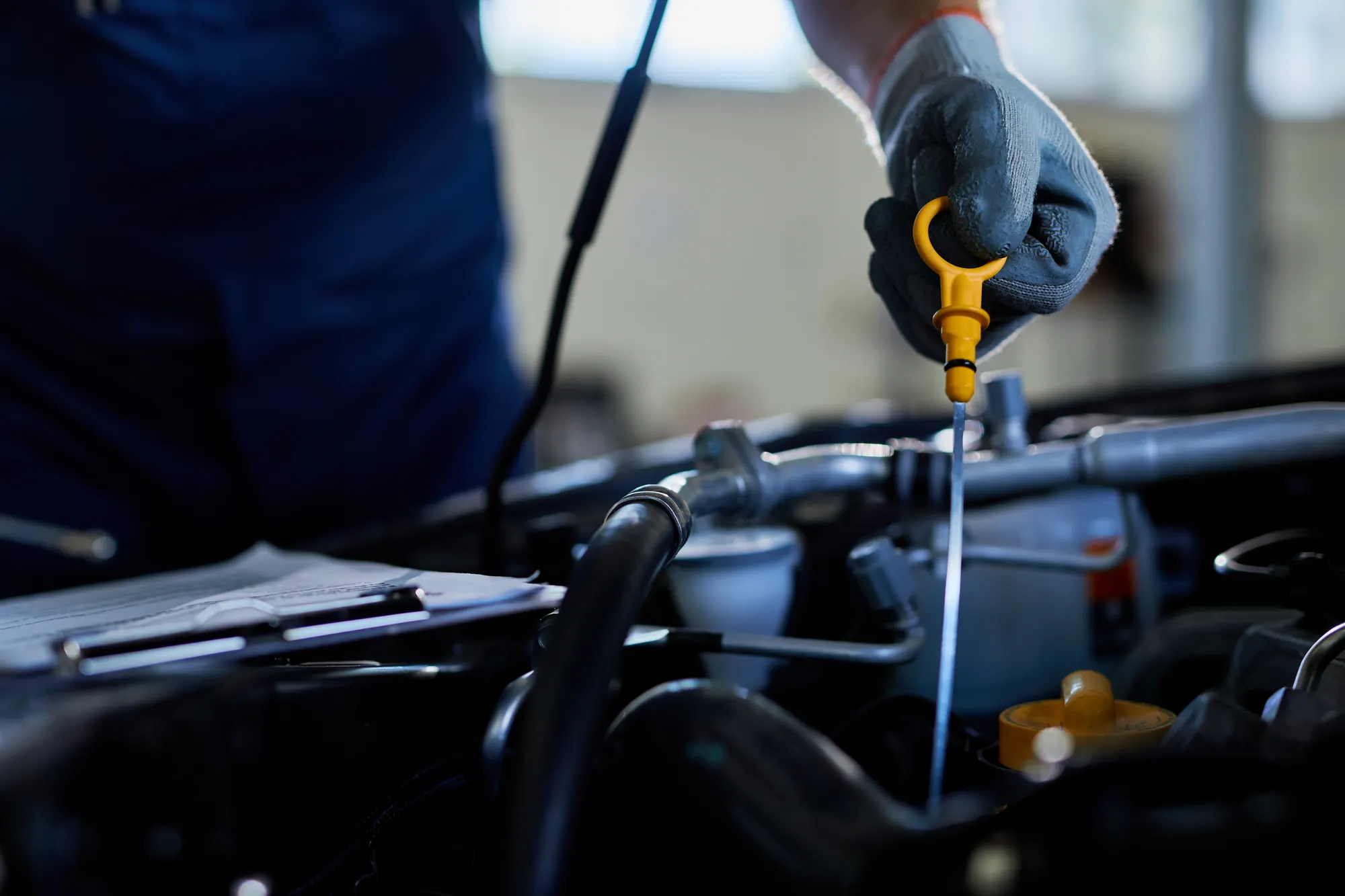 Technician carrying out a logbook service on a European car